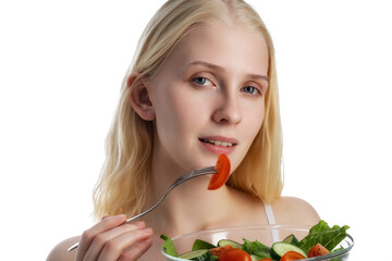 Good looking woman eating a bowl of salad while standing against a white background