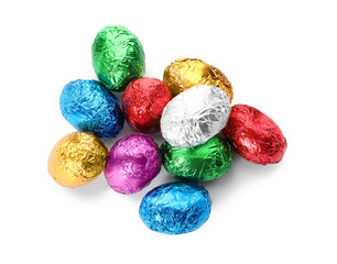 Fototapeta na wymiar Chocolate eggs wrapped in colorful foil on white background, top view