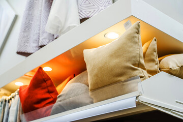 Multi-colored pillows on the counter in the store. Bedroom accessories trade. Close-up