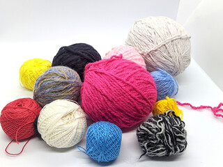 many colored balls of thread. many colored balls of thread on a white background side view