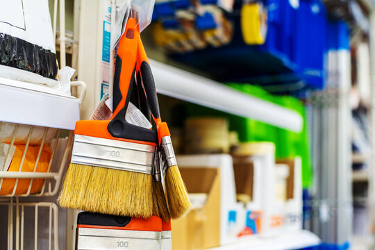 Flat brush for oil paints with natural bristles on the display case. An assortment of painting tools for interior decoration and renovation is sold in a specialist shop. Copy space Selective focus