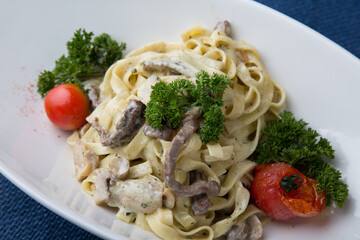 Pasta with beef, greens and tomatoes
