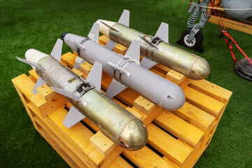 Bombs for unmanned aerial vehicles lie on a wooden pallet. Close-up