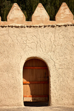 A dor in a sand-brick fortress wall in Al Ain
