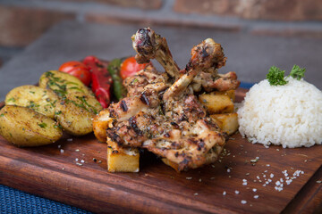 Grilled chicken with rice  tomatoes and potatoes 