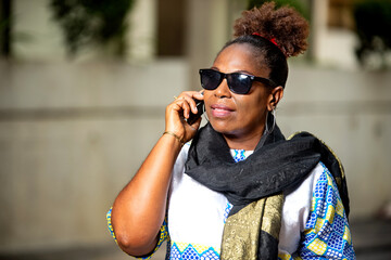 beautiful mature businesswoman talking on mobile phone outside.