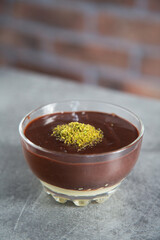 Chocolate pudding dessert with granulated pistachio 