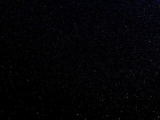 Obraz premium Black glittering background, wallpaper, white dots, night starry sky