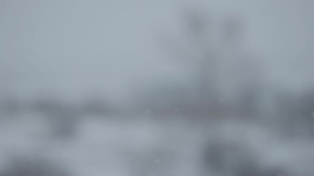 Slow motion blurred background of snowfall with fields on background