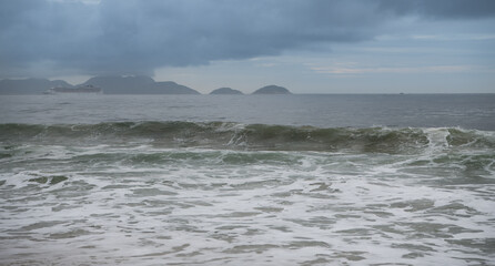 Ocean surf on the beach of Copacabana. Rio de Janeiro, February 2020