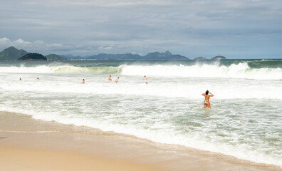   Citizens swim and sunbathe on the beach of Copacabana