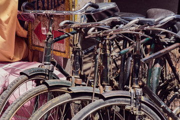 Obraz premium A detail of four parked rusty, old bicycles in Delhi, India