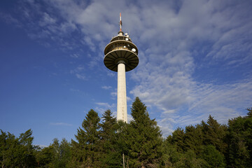 Telecommunications, transmission and radio tower from the german Telekom AG. Green trees. Germany,...