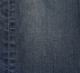 Fade denim jeans with seam at left side. Material, fabric, background textures categories.