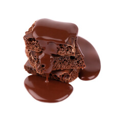 Porous chocolate pieces and chocolate syrup, isolated on white background. Black aerated chocolate.