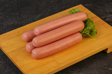 Tasty meat sausages over board