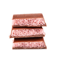 Porous chocolate pieces isolated on white background. Pink strawberry aerated chocolate.