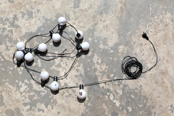 Old bulbs are arranged in different ways on the cement floor. 