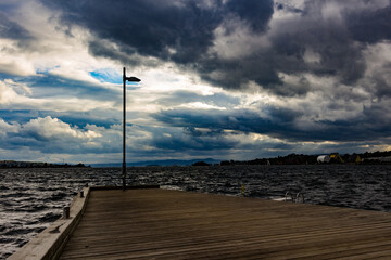 the lantern at the end of the pier with gloomy weather