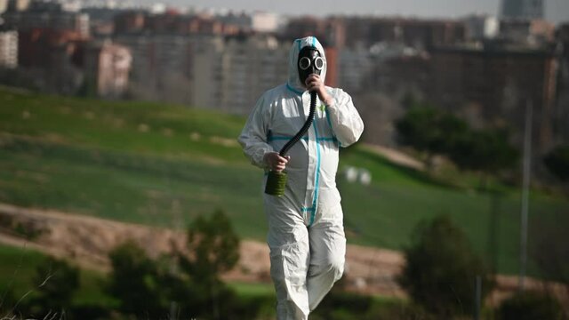 A person with a EPI virus suit and a gas mask on their face