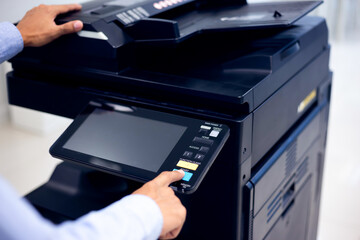 Bussiness man Hand press button on panel of printer, printer scanner laser in office copy machine supplies start concept.