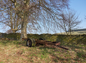 The Bare Chassis of a Four Wheel Trailer lies abandoned in a cornerof a Field in Dunnichen, Forfar. Angus, Scotland.