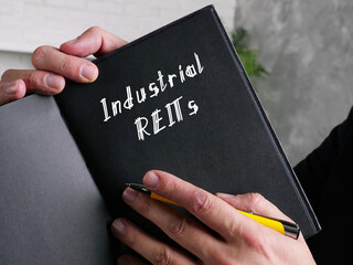  Financial concept meaning Industrial REITs with sign on the sheet.