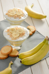 Fresh bananas, cookies and two portions of cream dessert