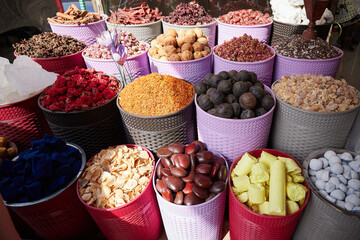 Colorful boxes with dried spices, tea and incense at bazaar market in Dubai