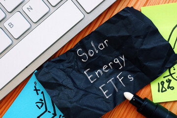 Business concept meaning Solar Energy ETFs with sign on the page.