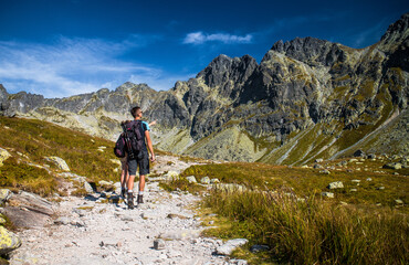 Couple pointing and looking at mountains while hiking