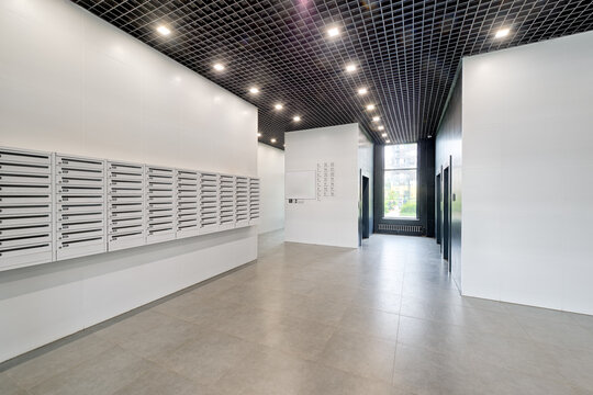 Large Empty Lobby Of An Apartment Building With Lots Of Mailboxes