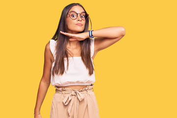 Young hispanic woman wearing casual clothes and glasses cutting throat with hand as knife, threaten aggression with furious violence