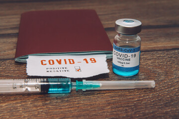 Coronavirus and travel concept, a note COVID-19 in tourist passport. Medical test at border control...