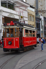 Fototapeta na wymiar Istanbul - Turkey - The famous red tram in Taksim square, attraction for many tourists.