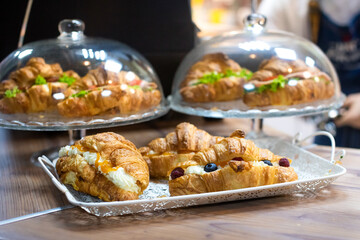 Fototapeta na wymiar cafeteria tray with homemade scones and croissants. fresh appetizing pastries.