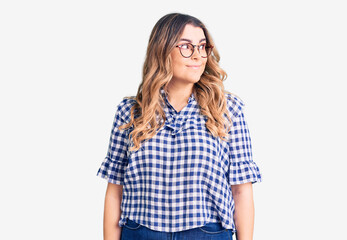 Young caucasian woman wearing casual clothes smiling looking to the side and staring away thinking.