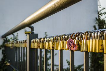 Petrovaradin, Serbia - February 05. 2021: Petrovaradin fortress; Padlocks of love on the fence