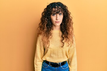 Young hispanic girl wearing casual clothes skeptic and nervous, frowning upset because of problem....