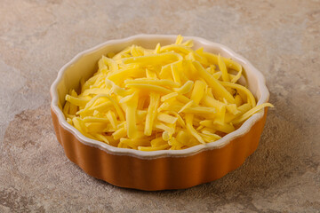 Shredded yellow cheese in the bowl