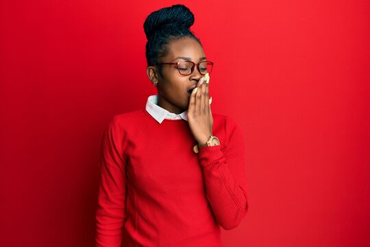 Young african american woman wearing casual clothes and glasses bored yawning tired covering mouth with hand. restless and sleepiness.