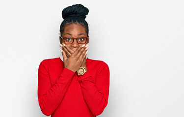 Young african american woman wearing casual clothes and glasses shocked covering mouth with hands for mistake. secret concept.