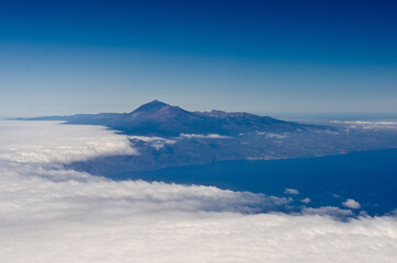 Aerial view of the Pico de Teide volcano emerging from clouds, Tenerife