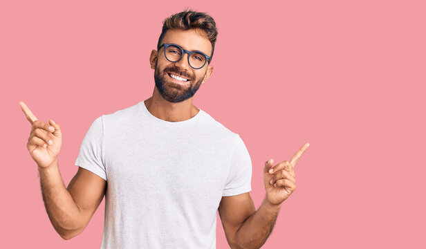 Young hispanic man wearing casual clothes and glasses smiling confident pointing with fingers to different directions. copy space for advertisement