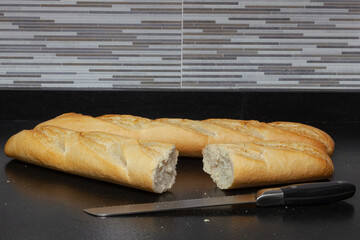 Two loaves of bread and a knife to cut it