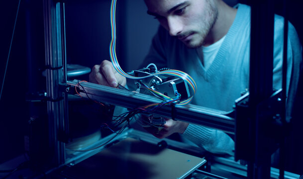Young engineer working on a 3D printer