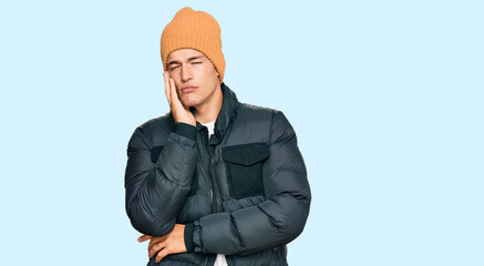 Handsome caucasian man wearing snow wear thinking looking tired and bored with depression problems with crossed arms.