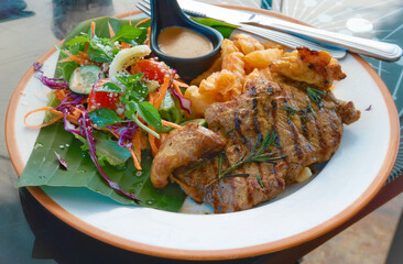 Closeup beef steak with salad and frenchfries