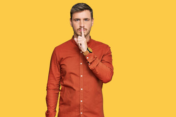 Handsome caucasian man wearing casual clothes asking to be quiet with finger on lips. silence and secret concept.