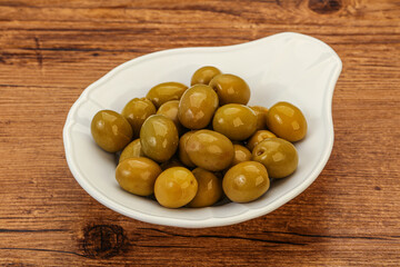 Green pickled olives in the bowl